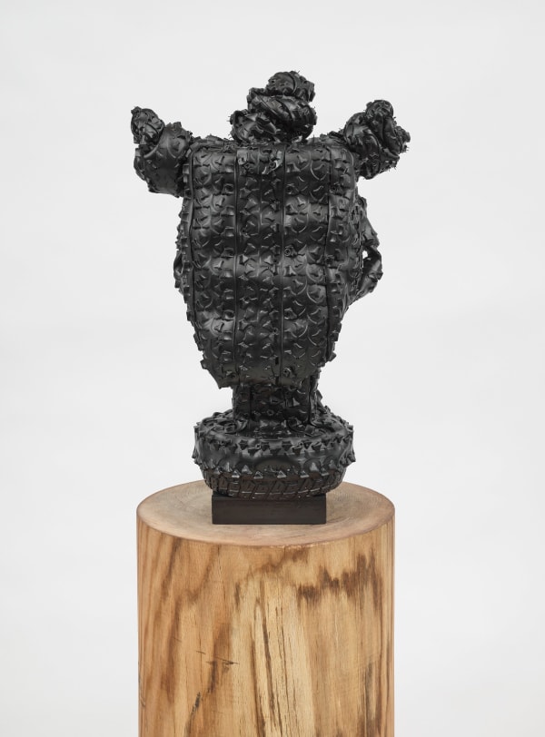 Kim Dacres Nubia, 2023 Recycled auto, motorcycle, electric skateboard, and bicycle tires, pressure treated wood, construction screws, and black satin spray paint mounted on pin oak plinth 23 1/2 x 15 x 11 3/4 inches (59.7 x 38.1 x 29.8 cm) Plinth: 40 x 14 inches (101.6 x 35.6 cm)