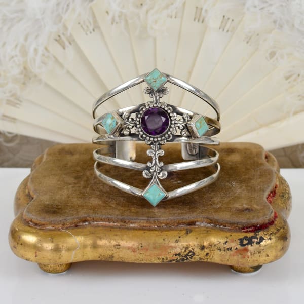 Jill Garber, FIGURAL RELIQUARY CROSS AMETHYST CENTER AND FOUR KINGMAN CABOCHONS