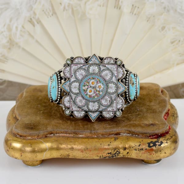 Jill Garber, A wonderful cuff bracelet having at its center a late 18th to early 19th Century complex layered micro mosaic expertly crafted in various shades from teal, aqua, pink and ivory tesserae