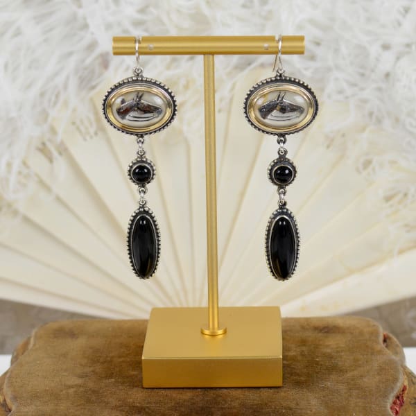 Jill Garber, A Handsome pair of attached wire chandelier earrings comprised of a set original early 20th Century English intaglio’s depicting horses heads that are rendered in various shades of brown, and black, reverse painted within crystal