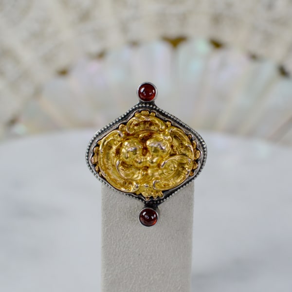 Jill Garber, WISDOM RING WITH RARE EIGHTEEN KARAT GOLD REPOUSSE’ ANGELS COMBINED WITH GARNET CABOCHONS