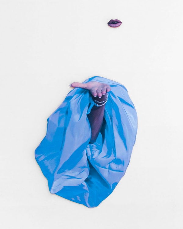 An inkjet print of an arm reaching out of a voluminous blue sleeve gesturing upward to a pair of floating lips, titled “Blurring Fantasy and Reality” by artist Julie Henson.