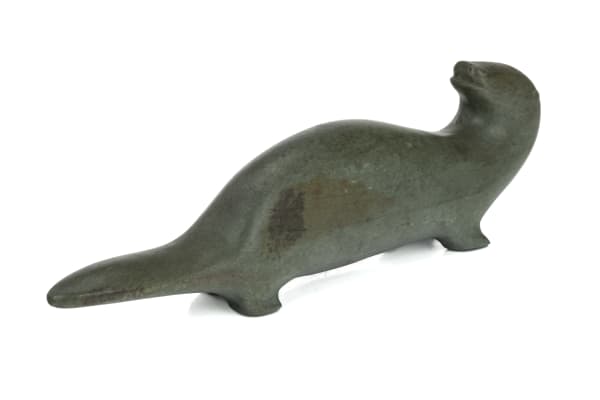 Lot 44 UNIDENTIFIED INUIT ARTIST, PROBABLY SANIKILUAQ (BELCHER ISLANDS) or KUUJJUARAPIK (GREAT WHALE RIVER) Otter Looking Back, c. mid-late 1950s stone, 2.5 x 8 x 1.25 in (6.3 x 20.3 x 3.2 cm) ESTIMATE: $400 — $600 PRICE REALIZED: $366.00
