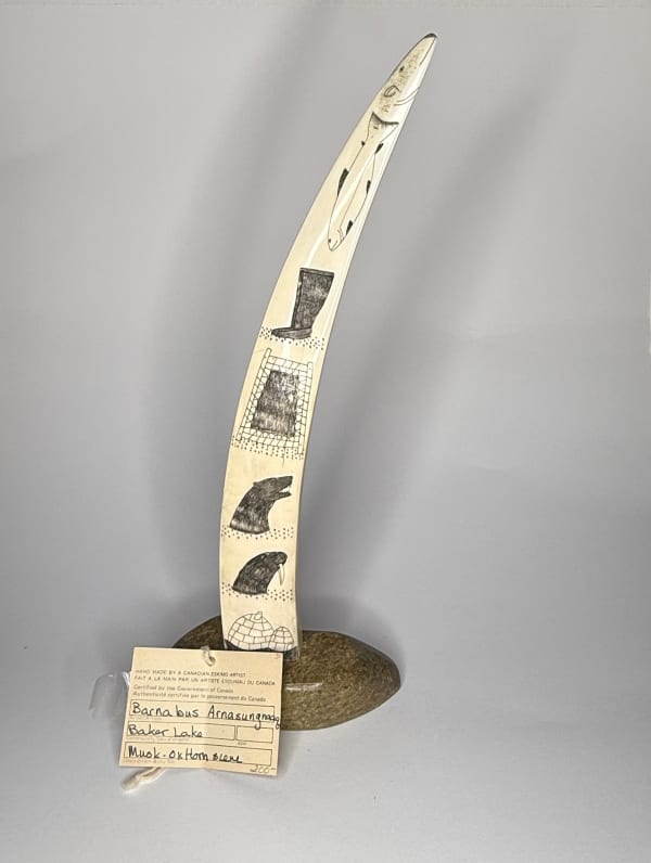 Lot 18 Possibly JOE ARLOOKTOO (1939-) KIMMIRUT (LAKE HARBOUR) Incised Tusk with Arctic Motifs, c. 1970 ivory, stone, and black ink, 12.75 x 4.75 x 3 in (32.4 x 12.1 x 7.6 cm) ESTIMATE: $500 — $800