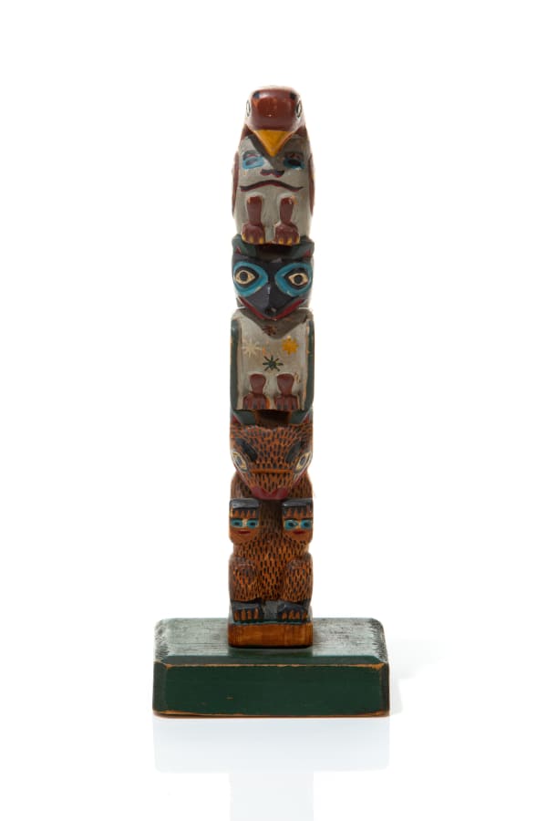 LOT 39 ELI TAIT, TLINGIT Model "Good Luck" Kasaan Bay Totem carved and polychromed wood, 9.25 x 2.5 x 3.5 in (23.5 x 6.3 x 8.9 cm) ESTIMATE: $700 — $900