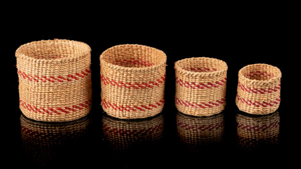 15 PRIMROSE ADAMS (1926-2020) HAIDA Nesting Baskets, c. 1980s spruce root and dyed grass, the largest: 1.5 x 1.5 x 1.5 in (3.8 x 3.8 x 3.8 cm)