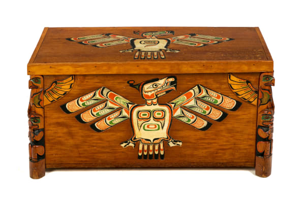 Lot 11 GEORGE SIWIS NELSON (1884-1969) KWAKWA̱KA̱ʼWAKW/QUATSINO FIRST NATION Chest with Thunder bird Motifs and Model Totems Corners, c. 1930s / 1940s cedar wood and pigment, 15.5 x 38 x 16.75 in (39.4 x 96.5 x 42.5 cm) ESTIMATE: $4,000 — $6,000 PRICE REALIZED: $5,124.00