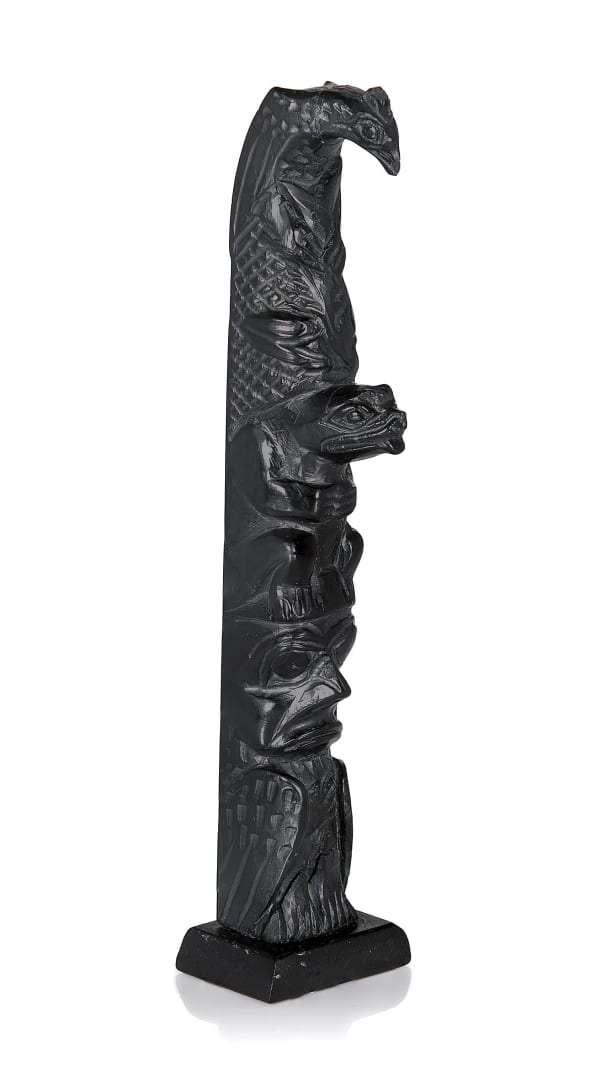 Lot 67 CAPTAIN ANDREW BROWN (1879-1962), HAIDA,MASSET, HAIDA GWAII Model Totem Pole, c. 1950s / 1960s argillite, 7.25 x 1.5 x 1 in (18.4 x 3.8 x 2.5 cm) ESTIMATE: $400 — $600 PRICE REALIZED: $976.00