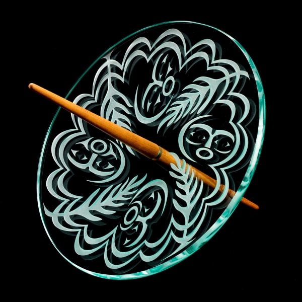 Lot 139 SUSAN POINT, C.C., R.C.A., O.B.C (1952-) MUSQUEAM, COAST SALISH Spindle Whorl: People of the Earth, c. 1995-2000 etched glass and wood, 14 x 23 x 7.5 in (35.6 x 58.4 x 19.1 cm) ESTIMATE: $4,000 — $6,000 PRICE REALIZED: $3,600.00