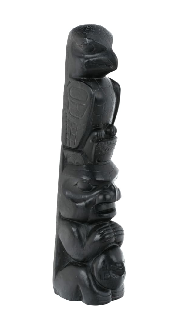 Lot 16 PAUL JONES (c. 1847-1927), SKIDEGATE, HAIDA GWAII Model Totem Pole, c. 1900s argillite, 9 x 2.5 x 2 in (22.9 x 6.3 x 5.1 cm) ESTIMATE: $1,500 — $2,500 PRICE REALIZED: $1,708.00