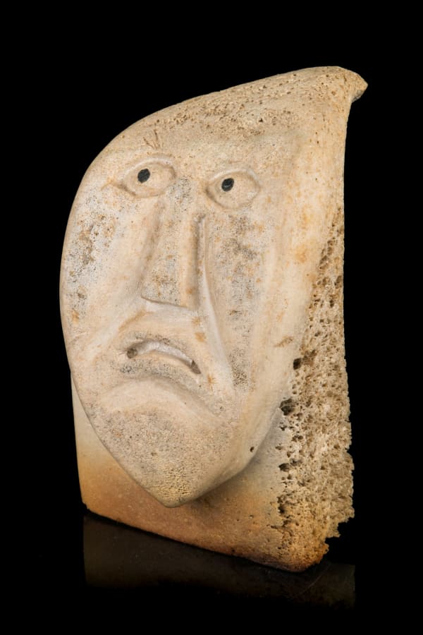 Lot 22 Probably SAMUEL NAHAULAITUQ (1923-1999) TALOYOAK (SPENCE BAY) Grimacing Inuk, 1980s whale bone and stone, 4.5 x 3 x 3.5 in (11.4 x 7.6 x 8.9 cm) ESTIMATE: $400 — $600 PRICE REALIZED: $292.80