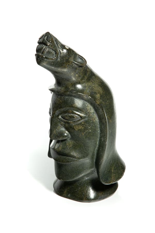 LOT 76 NUVEEYA (NOOVEEYA) IPELLIE (1920-2010) IQALUIT (FROBISHER BAY) Shaman with Polar Bear Spirit Helper, late 1970s stone and inlay, 12 x 6.75 x 7 in (30.5 x 17.1 x 17.8 cm) ESTIMATE: $1,000 — $1,500 PRICE REALIZED: $840.00
