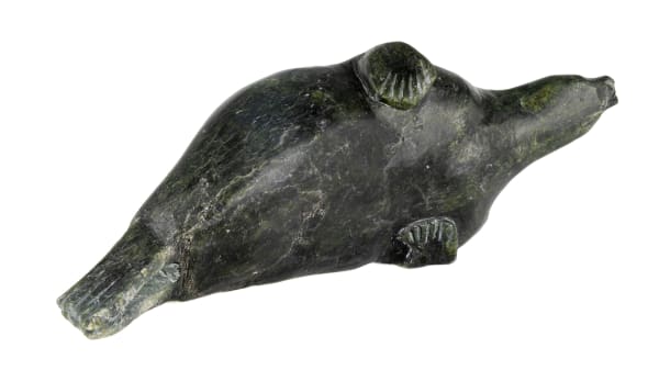 Lot 6 Probably SIMIGAK SIMEONIE (1939-2004) KINNGAIT (CAPE DORSET) Lounging Seal, 1962 stone, 3.75 x 11 x 3.75 in (9.5 x 27.9 x 9.5 cm) ESTIMATE: $250 — $350 PRICE REALIZED: $122.00