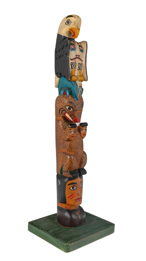 Lot 130 ELI TAIT (1872-1949) ALASKAN TSIMSHIAN, METLAKATLA, ALASKA “Good Luck” Model Totem Pole, 1930s cedar wood and paint, 17 x 5.5 x 5.5 in (43.2 x 14 x 14 cm) ESTIMATE: $2,500 — $3,500