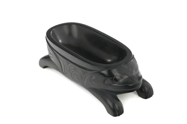 Lot 90 PAT DIXON (1938-2015) HAIDA Model Frog Form Feast Bowl, Feb 1988 argillite, 1.5 x 4.5 x 2 in (3.8 x 11.4 x 5.1 cm) ESTIMATE: $500 — $800 PRICE REALIZED: $480.00