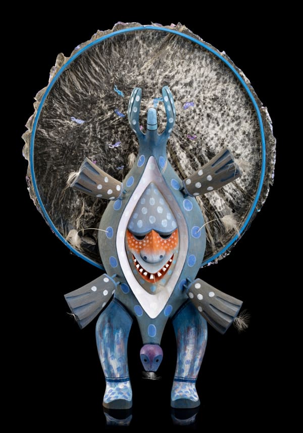 Lot 75 ROBERT JAMES (JIM) SCHOPPERT (1947-1992) TLINGIT Seal Dancer Spirit Drum, 1983 wood, acrylic paint, feathers, and embroidery floss 36 x 24 x 8 in (91.4 x 61 x 20.3 cm) ESTIMATE: $25,000 — $35,000 price realized: $21,960.00