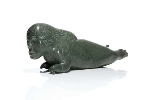 Lot 60 JIMMY IQALUQ (1947-) SANIKILUAQ (BELCHER ISLAND) Swimming Sedna with Shell-like Ears, c. 1970s stone, 5.5 x 18.25 x 3.5 in (14 x 46.4 x 8.9 cm) PRICE REALIZED: $319.80