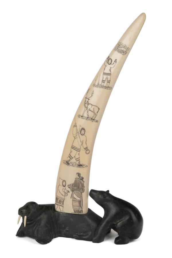 Lot 93 Attributed to ABRAHAM ETUNGAT, R.C.A. (1911-1999) KINNGAIT (CAPE DORSET) Incised Tusk Resting on Bear and Walrus Base, 1951 ivory, stone, and ink, 18 x 10.25 x 5.25 in (45.7 x 26 x 13.3 cm) ESTIMATE: $3,500 — $5,000