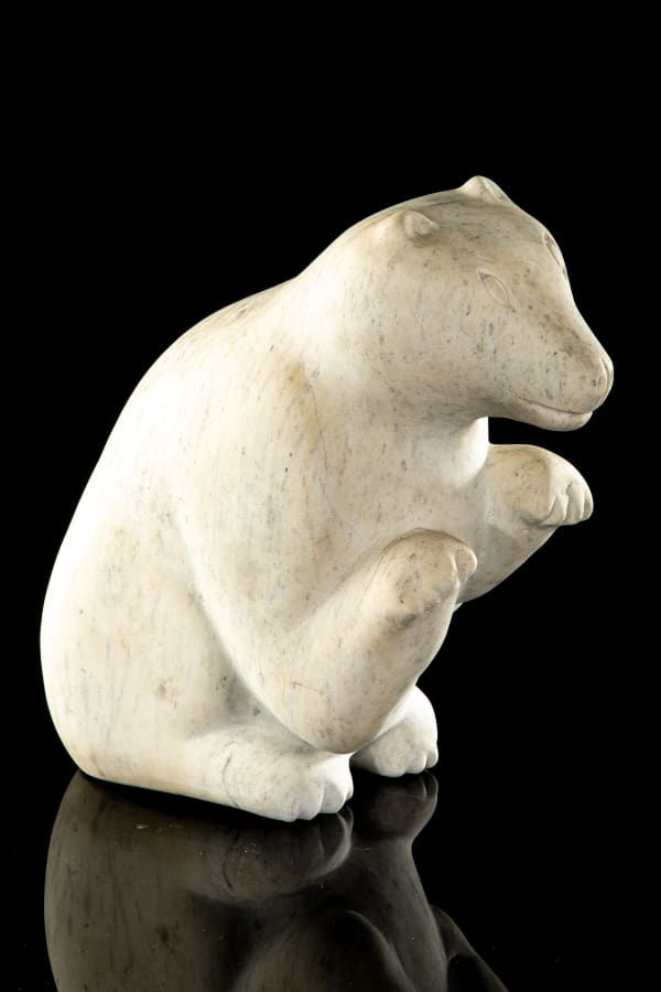 Attr: KENOJUAK ASHEVAK, C.C., R.C.A. (1927-2013) KINNGAIT (CAPE DORSET) Seated Dog stone, 14 x 12.5 x 6.75 in (35.6 x 31.8 x 17.1 cm)