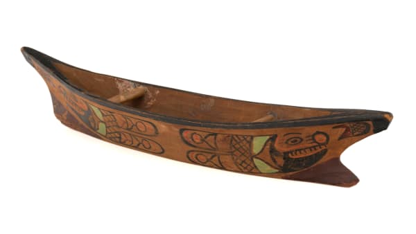 Lot 43 UNIDENTIFIED EYAK OR YAKUTAT TLINGIT ARTIST Yakutat-Style Model Canoe, c. 1920 wood and pigment, 2 x 11 x 2.5 in (5.1 x 27.9 x 6.3 cm) ESTIMATE: $300 — $500 PRICE REALIZED: $292.80