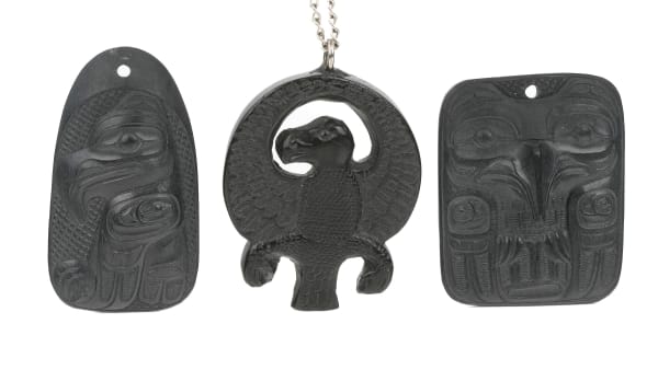 Lot 30 CLAUDE DAVIDSON (1924-1991), HAIDA, MASSET / ED RUSS (1953-2006), HAIDA Three Pendants, 1974 & c. 1990s the first, by Claude Davidson, argillite, 2 x 1.5 x 0.25 in (5.1 x 3.8 x 0.6 cm) ESTIMATE: $200 — $300 PRICE REALIZED: $366.00