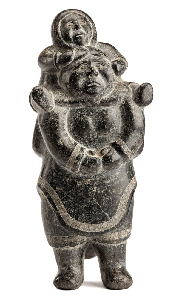 Lot 26 NIVIAQSI (NIVIAKSIAK) (1908-1959) KINNGAIT (CAPE DORSET) Mother with a Child on Her Shoulders,, c. 1955 stone, 12.25 x 5.5 x 4.5 in (31.1 x 14 x 11.4 cm) ESTIMATE: $10,000— $15,000 PRICE REALIZED: $18,000.00
