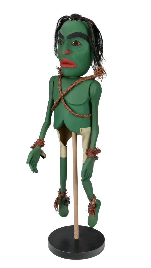 Lot 112 DAVID NEEL, KWAKWA̱KA̱ʼWAKW Model Tokwit Puppet, 1994 cedar wood, hair, deer hooves, stones, and hammered cedar bark, 46 x 11 x 7.5 in (116.8 x 27.9 x 19.1 cm) ESTIMATE: $3,000 — $5,000