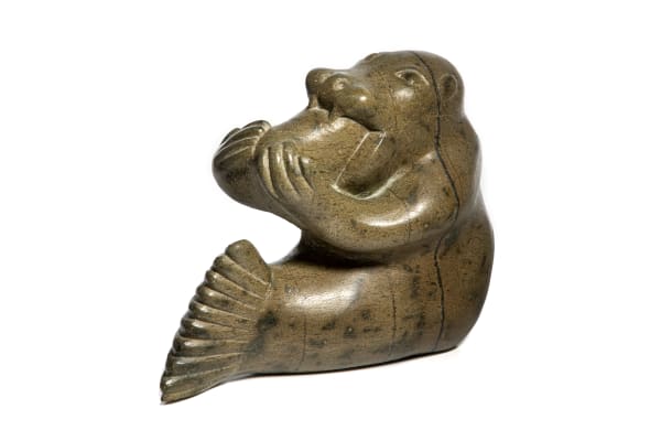 LOT 115 KOOMWARTOK ASHOONA (1930-1984) KINNGAIT (CAPE DORSET) Walrus Shaman Eating Fish, early-mid 1970s stone, 9 x 11.25 x 5.5 in (22.9 x 28.6 x 14 cm) ESTIMATE: $600 — $900