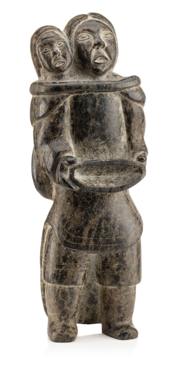 Lot 108 QAQAQ (KAKA) ASHOONA (1928-1996) KINNGAIT (CAPE DORSET) Standing Mother and Child, Holding a Qulliq, c. 1955 stone, 14.25 x 5 x 3.25 in (36.2 x 12.7 x 8.3 cm) ESTIMATE: $7,000 — $10,000 PRICE REALIZED: $7,200.00