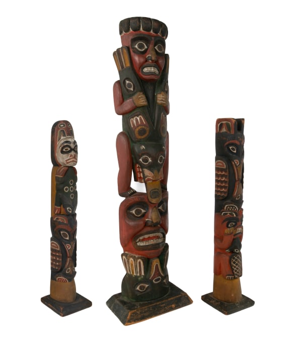 Lot 99 ALBERT BERRY SHOP CARVER / UNIDENTIFIED TLINGIT ARTIST Three Works: Two Divided Raven Totem (Kiks.ádi) Model Poles and One Strongman Splitting a Seal Sea Lion, before 1909 the largest: 21.75 x 6 x 4 in (55.2 x 15.2 x 10.2 cm) ESTIMATE: $7,000 — $10,000