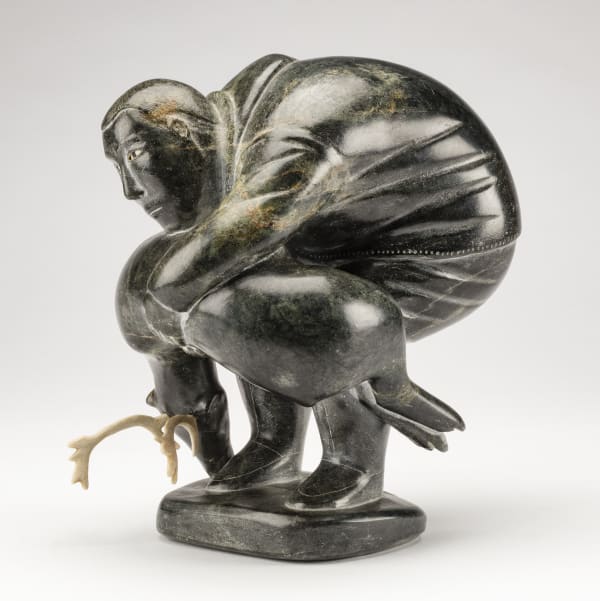 Lot 6 SAMISA PASSAURALU IVILLA (1924-1995) m., PUVIRNITUQ (POVUNGNITUK) Hunter Carrying a Caribou, c. 1958 stone, antler, ivory, and black inlay, 8.13 x 7.13 x 5.13 in (20.6 x 18.1 x 13 cm) ESTIMATE: $2,500 — $3,500 Price Realized: $4,320
