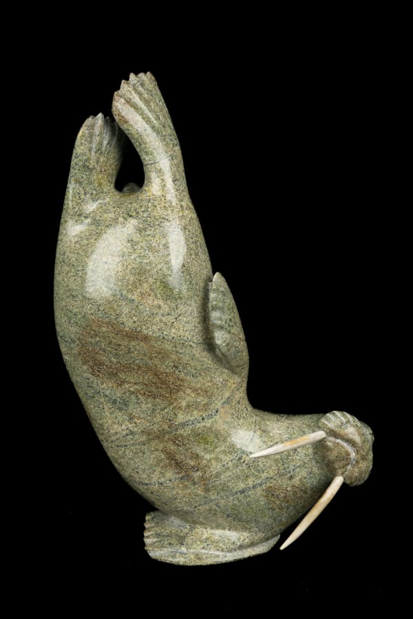 Lot 65 Probably KULULA ITULU (1952-) KINNGAIT (CAPE DORSET) Breeching Walrus, 1990s stone and antler, 9.75 x 6.5 x 3 in (24.8 x 16.5 x 7.6 cm) ESTIMATE: $600 — $900 PRICE REALIZED: $366.00