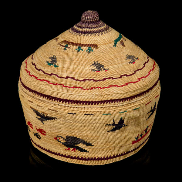 Lot 70 UNIDENTIFIED NUU-CHAH-NULTH ARTIST Lidded Pictorial Basket with Avian Forms and Whaling Scenes, c. 1980s natural grasses, dyes, and cedar bark, 5.25 x 5.5 x 5.5 in (13.3 x 14 x 14 cm) ESTIMATE: $500 — $800