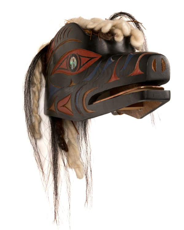 Lot 45 DR. CHARLES ELLIOTT (TEMOSEṈŦET/TEMOSEN) OBC, RCA (1943-2023) TSARTLIP COAST SALISH Wolf Spirit Mask, July 1994 cedar wood, wool yard, hair, acrylic paint, and pāua shell, 9 x 17 x 7 in (22.9 x 43.2 x 17.8 cm) ESTIMATE: $800 — $1,200 PRICE REALIZED: $2,074.00