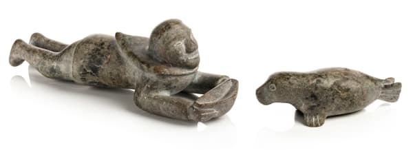 Lot 8 KENOJUAK ASHEVAK, C.C., R.C.A. (1927-2013) KINNGAIT (CAPE DORSET) Man with Qulliq, and Seal, 1964 stone, the man: 2.75 x 8 x 2.75 in (7 x 20.3 x 7 cm) ESTIMATE: $6,000 — $9,000 PRICE REALIZED: $6,000.00