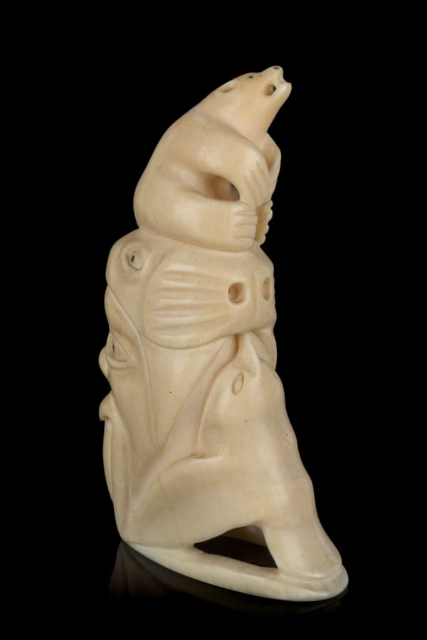 Lot 23 HENRY NAPARTUK (1932-1985) KUUJJUARAPIK (GREAT WHALE RIVER) Totemtic Composition with Arctic Animals, mid-late 1960s tooth and black inlay, 3.75 x 1 x 1.5 in (9.5 x 2.5 x 3.8 cm) ESTIMATE: $400— $600