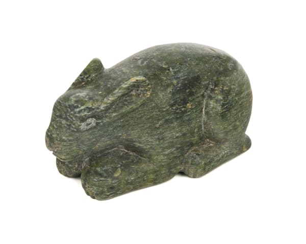 Lot 9 KANANGINAK POOTOOGOOK, R.C.A. (1935-2010) KINNGAIT (CAPE DORSET) Crouched Arctic Hare, 1958 stone, 1.5 x 4.5 x 2 in (3.8 x 11.4 x 5.1 cm) ESTIMATE: $900 — $1,200 PRICE REALIZED: $610.00