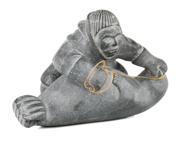 Lot 17 MOSES TALIA QUMA (1920-D) AKULIVIK Man Subduing a Seal, 1958 stone and waxed string, 4.75 x 7.25 x 4.25 in (12.1 x 18.4 x 10.8 cm) ESTIMATE: $200 — $400 PRICE REALIZED: $292.80
