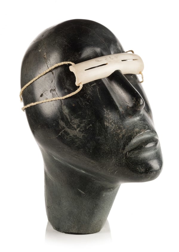 Lot 72 MOSES NAGYUGALIK (1910-1996) QAMANI’TUAQ (BAKER LAKE) Head of a Man Wearing Snow Goggles, 1968 stone, antler, and waxed twine, 8 x 4 x 7 in (20.3 x 10.2 x 17.8 cm) ESTIMATE: $5,000 — $8,000 PRICE REALIZED: $5,280.00