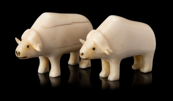 Lot 141 UNIDENTIFIED INUIT ARTIST, CENTRAL CANADIAN ARCTIC Two Ivory Muskoxen, c. early to mid 1950s each ivory and black inlay, 1.5 x 2.25 x 0.75 in (3.8 x 5.7 x 1.9 cm) ESTIMATE: $600 — $900 PRICE REALIZED: $793.00