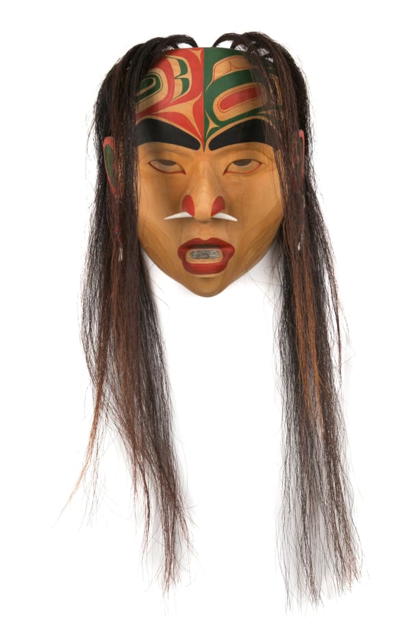 Lot 3 GLEN RABENA (1953-), NON-INDIGENOUS, ADOPTED HAIDA, HORNBY ISLAND Medicine Woman Portrait Mask, 2007 alder wood, abalone, dentalium shell, hair, antler, acrylic paint, fabric, and plastic beads, 12 x 9.5 x 4.25 in (30.5 x 24.1 x 10.8 cm) ESTIMATE: $1,800 — $2,800 PRICE REALIZED: $1,098.00