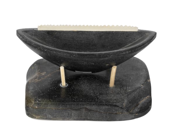 Lot 71 UNIDENTIFIED INUIT ARTIST, EASTERN CANADIAN ARCTIC Model Qulliq (Kudlik) on Base, late 1950s / early 1960s stone and ivory, 2.25 x 3.75 x 2.75 in (5.7 x 9.5 x 7 cm) ESTIMATE: $100 — $150 PRICE REALIZED: $146.40