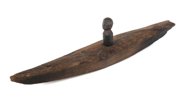 Lot 29 UNIDENTIFIED ARTIST, PROBABLY NORTHWESTERN ALASKA Toy of Man in Kayak, wood and ancient ivory, 10.5 x 1 x 1.75 in (26.7 x 2.5 x 4.4 cm) ESTIMATE: $150 — $250 PRICE REALIZED: $390.40
