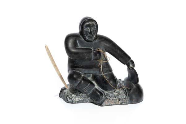 Lot 56 THOMASSIE TUKAI (1937-D) INUKJUAK (PORT HARRISON) Hunter with Catch, early 1960s stone, sinew, and antler, 7.5 x 7.5 x 4 in (19.1 x 19.1 x 10.2 cm) PRICE REALIZED: $319.80