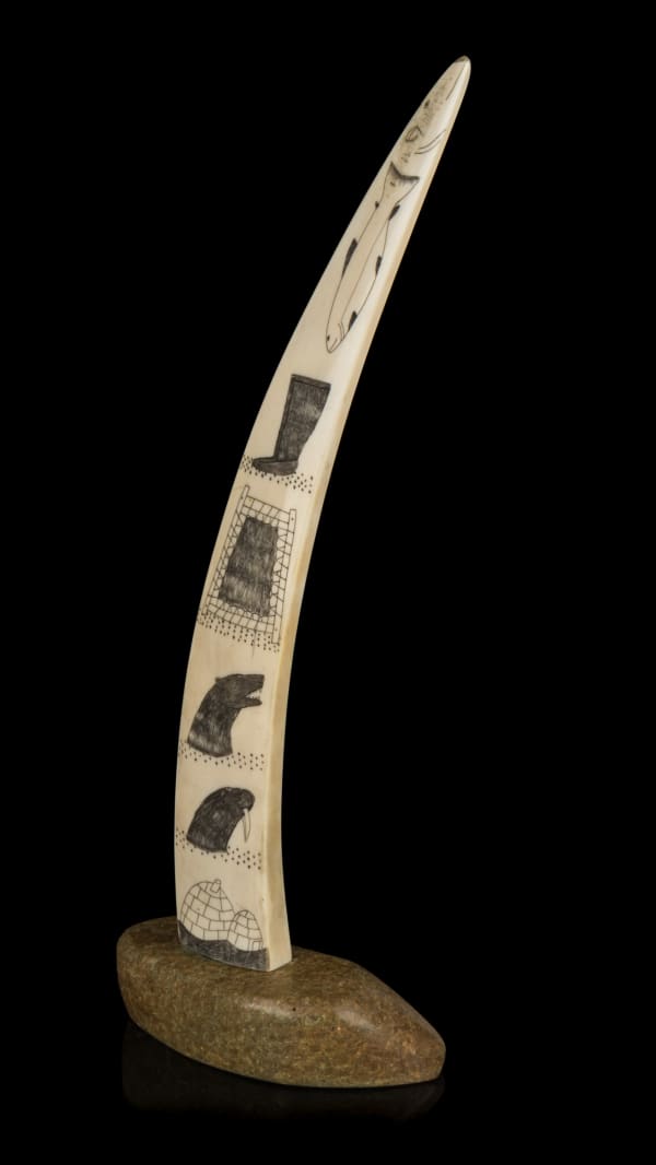 Lot 18 Possibly JOE ARLOOKTOO (1939-) KIMMIRUT (LAKE HARBOUR) Incised Tusk with Arctic Motifs, c. 1970 ivory, stone, and black ink, 12.75 x 4.75 x 3 in (32.4 x 12.1 x 7.6 cm) ESTIMATE: $500 — $800