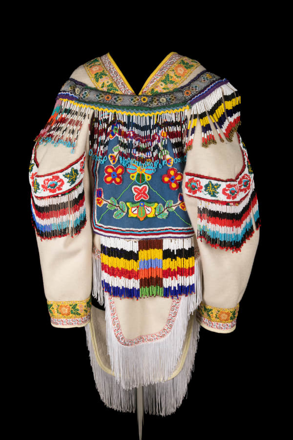 18 MELANIE KINNIKSIE, ARVIAT (ESKIMO POINT) Beaded Amautiq, 2002 stroud, wool duffel, cotton fabric, glass and plastic beads, cotton and polyester trims, fringe, yarn, sinew, and cotton thread, 47.5 x 24 x 22 in (120.7 x 61 x 55.9 cm)