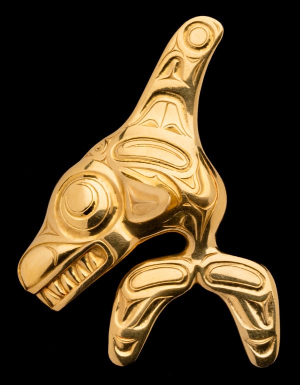 Lot 26 BILL REID (IIJUWAS), O.B.C., R.C.A. (1920-1998), HAIDA Killer Whale Brooch, 1972 testing 22 kt cast gold with chased and engraved highlights, 2.5 x 2 x 0.5 in (6.3 x 5.1 x 1.3 cm) ESTIMATE: $25,000 — $35,000 PRICE REALIZED: $26,400.00