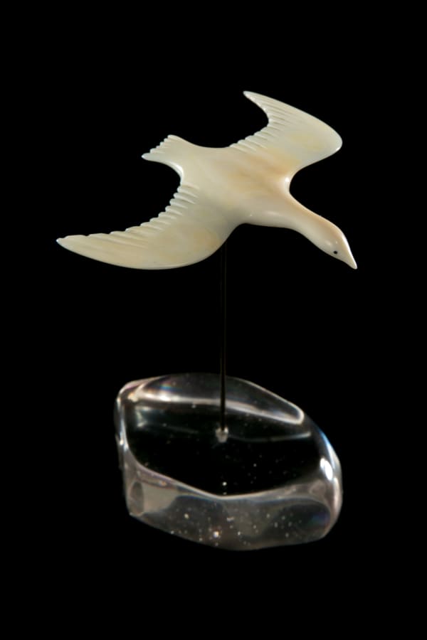 LOT 106 UNIDENTIFIED ARTIST, Probably NAUJAAT (REPULSE BAY) Bird in Flight antler, black inlay, with later added metal peg and glass base, 4 x 2.25 x 2 in (10.2 x 5.7 x 5.1 cm) ESTIMATE: $200 — $400 PRICE REALIZED: $192.00