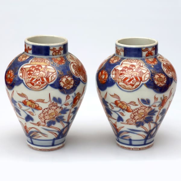 A pair of late 17th century Edo period Imari small vases with floral motifs.