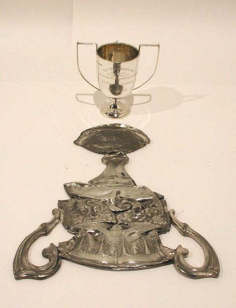 CORNELIA PARKER Alter Ego (Fruit Cake), 2004 Silver plated objects with squashed 'reflection' 30 (w) x 42 cm (d)